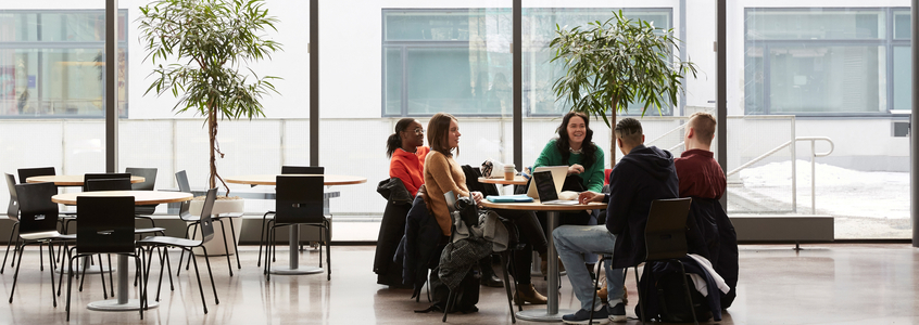 Full length of students talking while sitting at table in university graduate silhouette 2019 2020