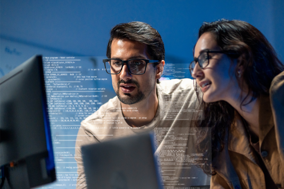 Man and woman looking at computer monitors